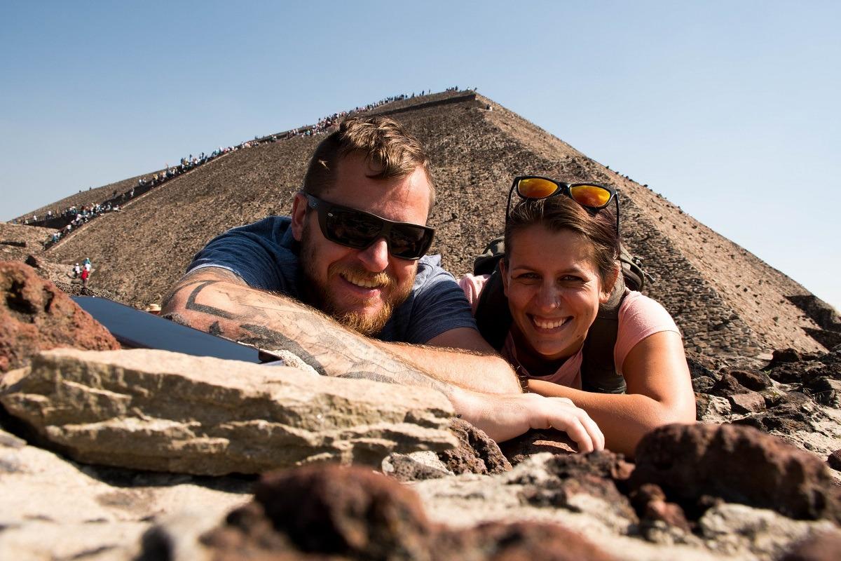 Us and pyramid of the sun behind, with many people climbing to the top