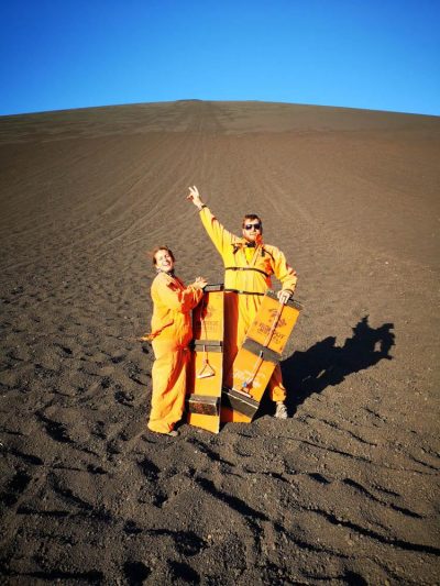 In orange onsies at the bottom of volcano (Volcano boarding in Leon, Nicaragua)