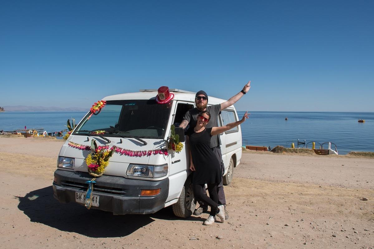 Us and our decorated van by the lake Titicaca in Bolivia