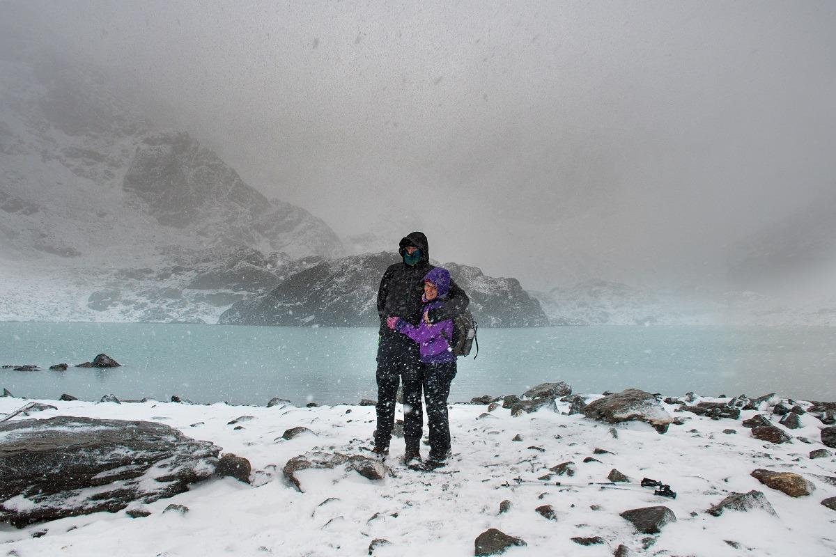 Us in the middle of the snowstorm, at the top of the mountain next to the glacial lake. (Hiking in Ushuaia)