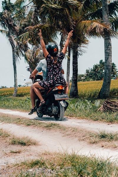 Us on a Motorbike in Bali - palm trees and rice fields (our yearlong honeymoon)