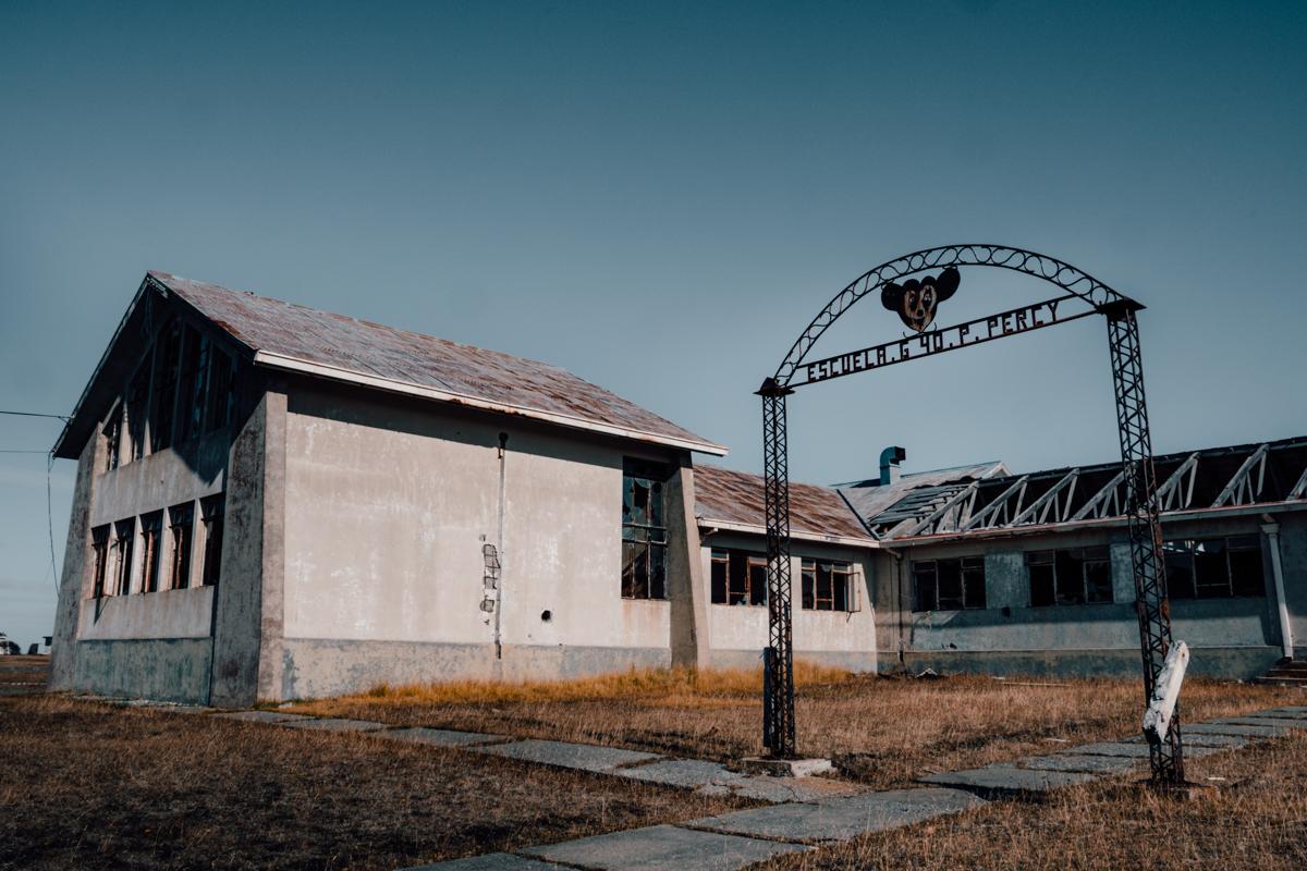 Deserted school with rusty Mickey Mouse sign (Unique towns in Patagonia)