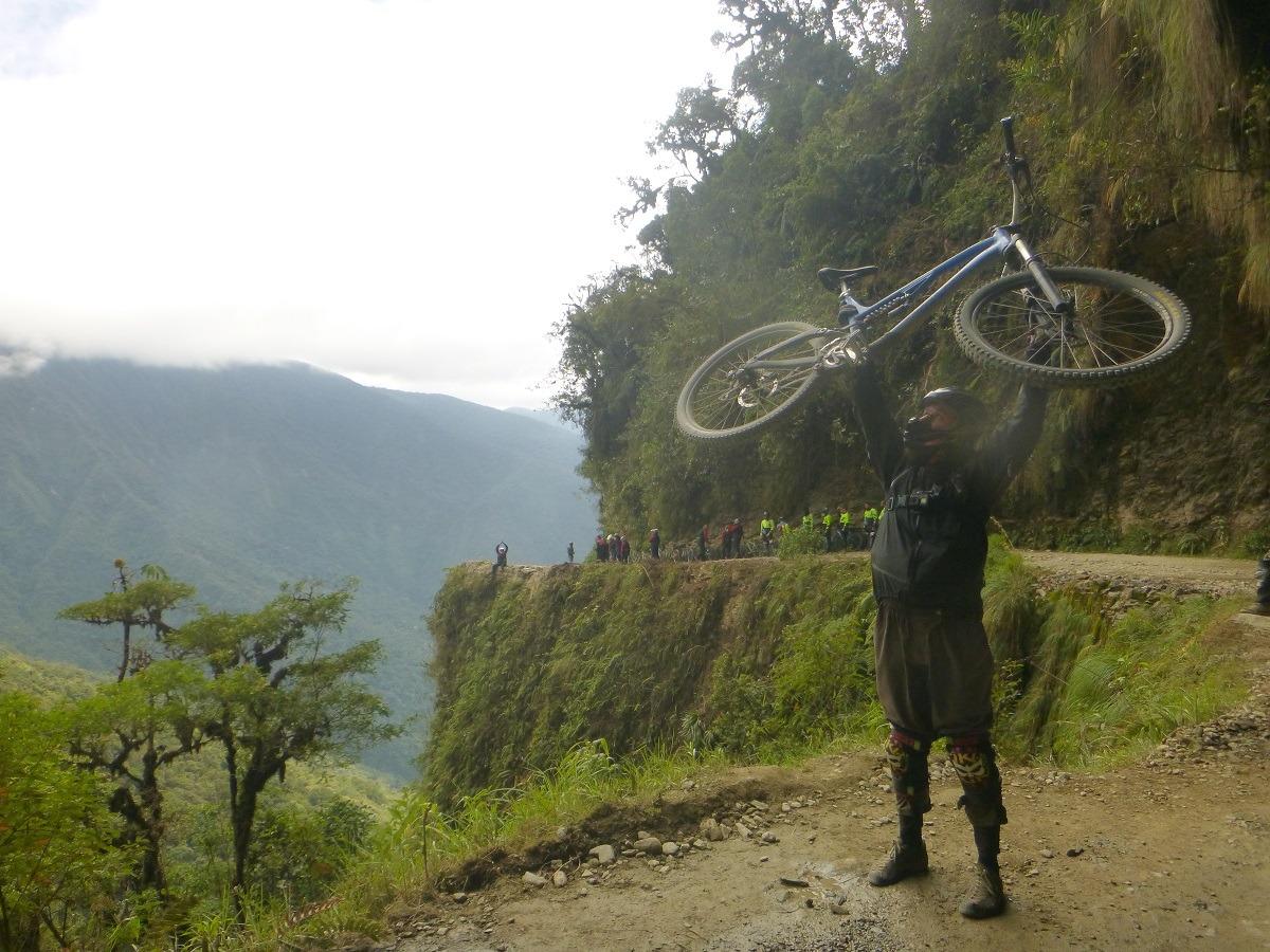 Bojan holding his bike on a Death Road Bolivia